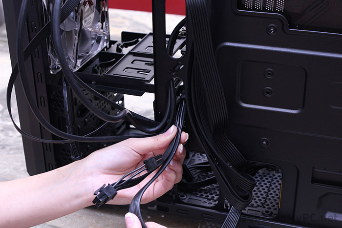 Placing PCIe cables through holes in the motherboard tray